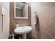 Elegant powder room featuring a pedestal sink, decorative wallpaper, and classic fixtures at 1831 Middlebrook Dr, Raleigh, NC 27615