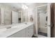 Bright bathroom featuring double sinks, ample counter space, and a tub/shower combo at 1831 Middlebrook Dr, Raleigh, NC 27615