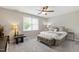 Inviting bedroom with a ceiling fan, neutral colors, and a large window providing natural light at 1831 Middlebrook Dr, Raleigh, NC 27615