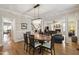 Formal dining area with chandelier, access to kitchen, and view into living room at 1831 Middlebrook Dr, Raleigh, NC 27615
