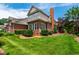 Brick home with a well-maintained lawn, mature landscaping and a brick chimney at 1831 Middlebrook Dr, Raleigh, NC 27615