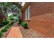Brick walkway, lush landscaping, and partial view of the house showing curb appeal at 1831 Middlebrook Dr, Raleigh, NC 27615