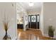 Bright foyer boasts hardwood floors, decorative front door and sidelights, and elegant lighting at 1831 Middlebrook Dr, Raleigh, NC 27615