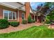 Charming brick home with well-manicured lawn, lush landscaping, and inviting curb appeal at 1831 Middlebrook Dr, Raleigh, NC 27615