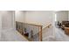 Upstairs hallway with wood railing, carpet, and access to a home office space at 1831 Middlebrook Dr, Raleigh, NC 27615