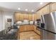Well-lit kitchen featuring stainless steel appliances, granite countertops, and hardwood floors at 1831 Middlebrook Dr, Raleigh, NC 27615
