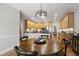 Well-designed kitchen connects to a dining area with light wood cabinets and granite countertops at 1831 Middlebrook Dr, Raleigh, NC 27615