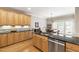 Spacious kitchen with granite counters, wood cabinets, and stainless steel appliances at 1831 Middlebrook Dr, Raleigh, NC 27615