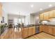 Bright eat-in kitchen with stainless appliances, black countertops, and hardwood floors at 1831 Middlebrook Dr, Raleigh, NC 27615