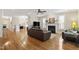 Open-concept living room featuring hardwood floors, a fireplace, and comfortable seating areas at 1831 Middlebrook Dr, Raleigh, NC 27615