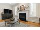 Bright living room with fireplace, TV, and unique coffee table with wood floors at 1831 Middlebrook Dr, Raleigh, NC 27615