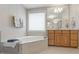 Elegant bathroom with a soaking tub, tile surround, and a large mirror above the vanity at 1831 Middlebrook Dr, Raleigh, NC 27615