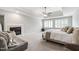 Spacious main bedroom featuring a fireplace, sitting area, ceiling fan, and abundant natural light at 1831 Middlebrook Dr, Raleigh, NC 27615