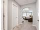 Hallway with open view of a carpeted main bedroom suite, complete with chair and window at 1831 Middlebrook Dr, Raleigh, NC 27615