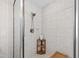 Modern tiled shower with glass doors, a rainfall showerhead, and a built-in shelf at 1831 Middlebrook Dr, Raleigh, NC 27615