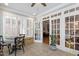 Bright sunroom with tile floors, shutters, and multiple windows creating a serene atmosphere at 1831 Middlebrook Dr, Raleigh, NC 27615