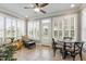Bright sunroom featuring tile flooring, plantation shutters, and charming furniture creating a cozy retreat at 1831 Middlebrook Dr, Raleigh, NC 27615