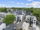 Aerial view of a modern neighborhood with contemporary homes, green spaces, and convenient parking at 219 Woodsborough Pl, Raleigh, NC 27601