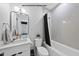Well-lit bathroom featuring a modern vanity, toilet, and a tub-shower combination at 219 Woodsborough Pl, Raleigh, NC 27601
