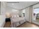 Bright bedroom with modern decor, including a cozy bed, soft lighting, and balcony access at 219 Woodsborough Pl, Raleigh, NC 27601