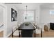 Elegant dining room featuring a modern chandelier, dark table, and seating for six at 219 Woodsborough Pl, Raleigh, NC 27601