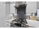 State-of-the-art kitchen with stainless steel range hood, sleek countertops, and a modern gas range at 219 Woodsborough Pl, Raleigh, NC 27601