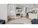 Inviting living area with fireplace, television, and seamless access to the modern kitchen at 219 Woodsborough Pl, Raleigh, NC 27601