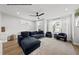 Spacious living room with a large sofa, plush armchairs, and lots of natural light at 219 Woodsborough Pl, Raleigh, NC 27601