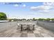 Rooftop deck with modern outdoor furniture and serene treetop views under a blue sky at 219 Woodsborough Pl, Raleigh, NC 27601