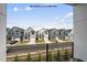 New homes lining a street showcase modern exteriors and well-maintained landscaping under a bright, cloudy sky at 219 Woodsborough Pl, Raleigh, NC 27601