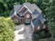 Aerial shot of brick home with manicured lawn, mature trees, and extended driveway at 230 Paula Dr, Angier, NC 27501
