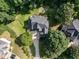 Aerial view of house with wooded backyard, long driveway, and manicured lawn at 230 Paula Dr, Angier, NC 27501