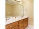Well-lit bathroom featuring double sinks, wood cabinets, and neutral colors at 230 Paula Dr, Angier, NC 27501