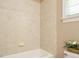 Bathroom with tiled shower/tub combo and decorative wall tiles at 230 Paula Dr, Angier, NC 27501