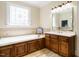 A serene bathroom showcasing a soaking tub beneath a stained glass window, complemented by a wooden vanity at 230 Paula Dr, Angier, NC 27501