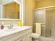 Bathroom with neutral colored walls, tile flooring, white cabinets and tub with shower at 230 Paula Dr, Angier, NC 27501