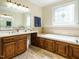 Bathroom vanity and soaking tub with decorative window create a peaceful retreat at 230 Paula Dr, Angier, NC 27501