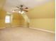 Spacious carpeted bedroom featuring a ceiling fan and natural light at 230 Paula Dr, Angier, NC 27501