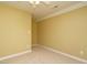 Empty bedroom with neutral carpet, cream trim, and warm yellow walls at 230 Paula Dr, Angier, NC 27501