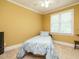 Cozy bedroom featuring a single bed with floral bedding and a sunny window at 230 Paula Dr, Angier, NC 27501