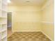 Walk in closet with tile flooring and white wire shelving with neutral walls at 230 Paula Dr, Angier, NC 27501