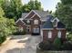 Beautiful brick home with a well-manicured lawn and a side-entry two-car garage at 230 Paula Dr, Angier, NC 27501