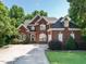 Beautiful two story brick home with manicured lawn, mature landscaping, and an extended driveway at 230 Paula Dr, Angier, NC 27501