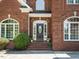 Close up of the front door and entryway, including mature landscaping at 230 Paula Dr, Angier, NC 27501