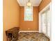 Hallway with bright orange walls, a window, an entry door and decorative tile floors at 230 Paula Dr, Angier, NC 27501