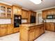 Spacious kitchen featuring a large island, custom wood cabinets, and modern appliances at 230 Paula Dr, Angier, NC 27501