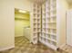 Laundry room with washer, dryer, overhead lighting, tile floors and lots of shelving at 230 Paula Dr, Angier, NC 27501