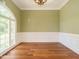 Bright living room featuring large windows with hardwood floors and elegant trim work at 230 Paula Dr, Angier, NC 27501
