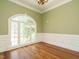 Bright living room featuring large windows with hardwood floors and elegant trim work at 230 Paula Dr, Angier, NC 27501