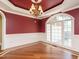 Living room featuring large windows with hardwood floors, chair railing, and elegant trim work at 230 Paula Dr, Angier, NC 27501